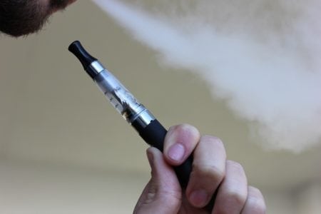 Man Smoking an E-Cigarette | Is There a Link Between Vaping and Lung Cancer? | SERO Blog