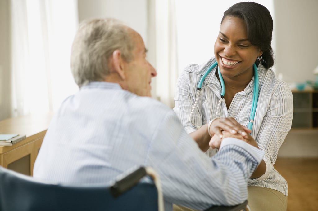 Nurse and elderly man spending time together