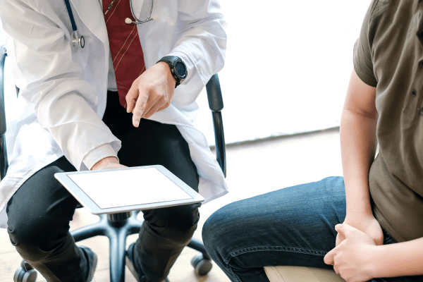 Doctor going over states of prostate cancer with patient