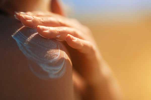 applying sunscreen for sun protection against skin cancer